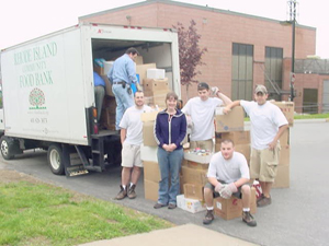 A crew helping load a food bank truck
